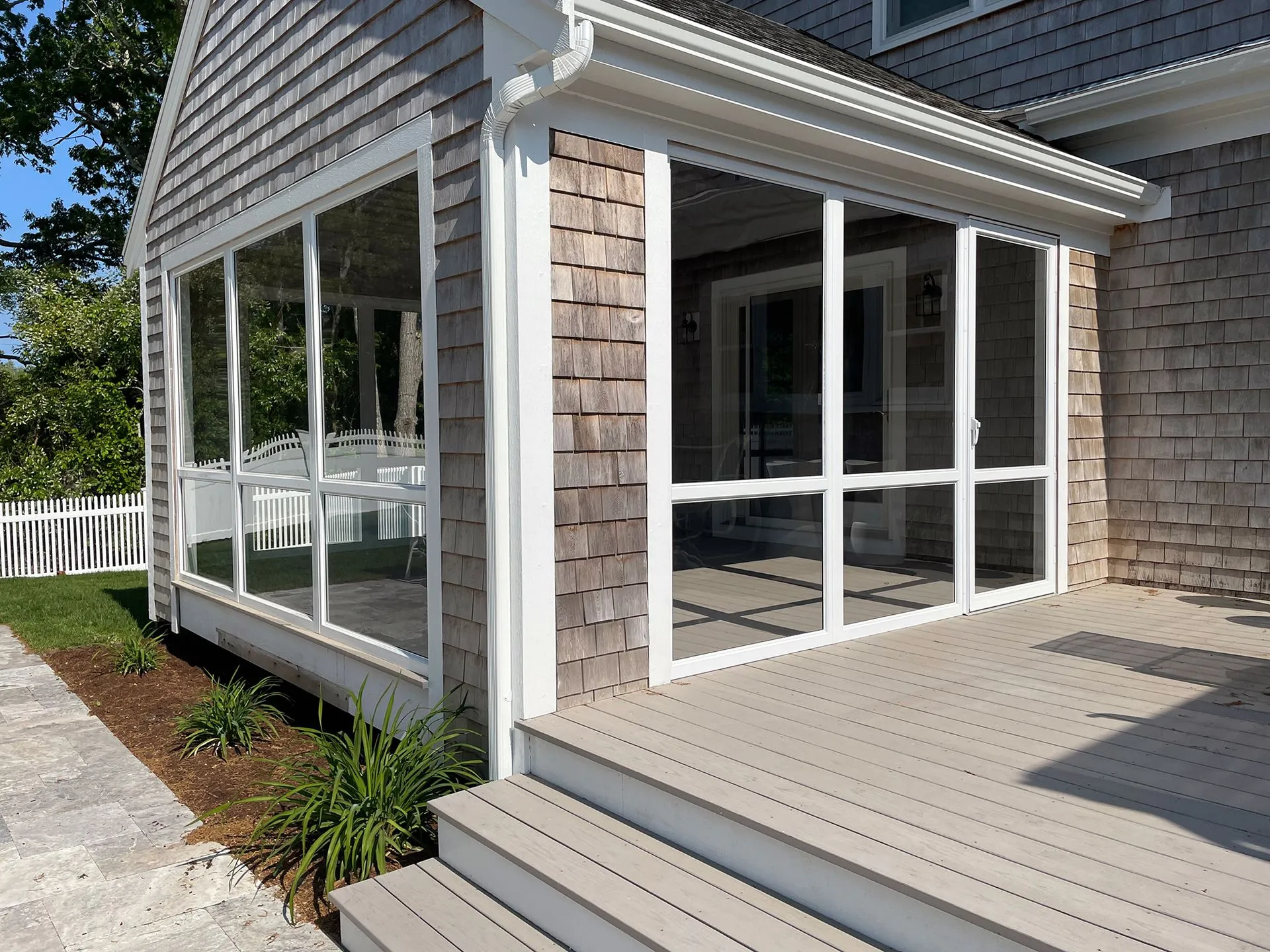 a screened in porch on the side of a house