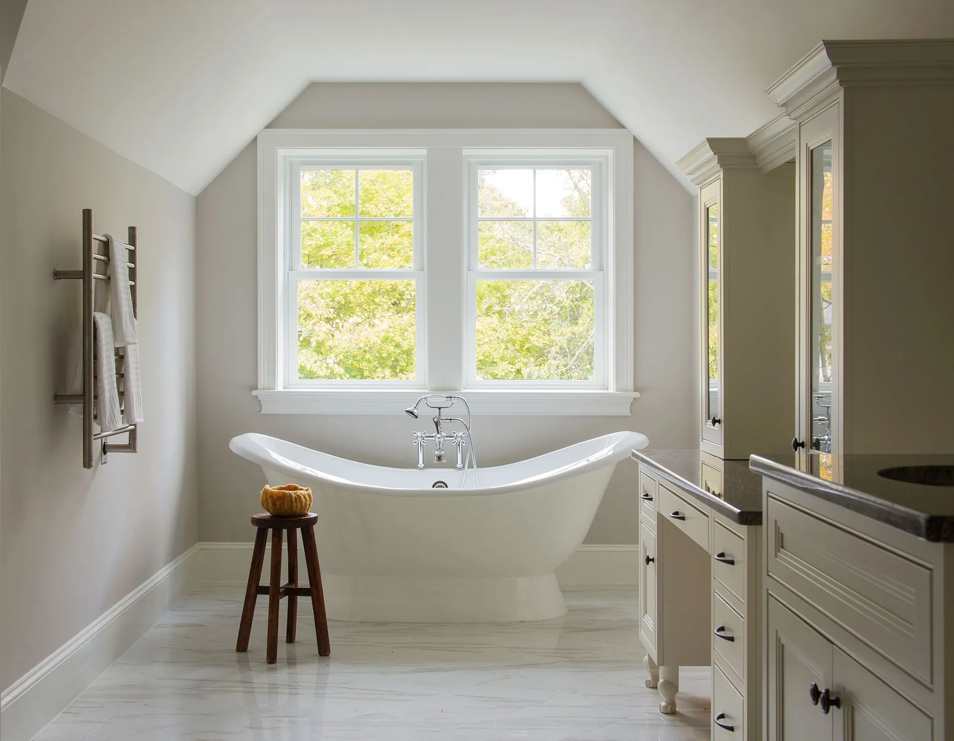 a bathroom with a bathtub and two windows