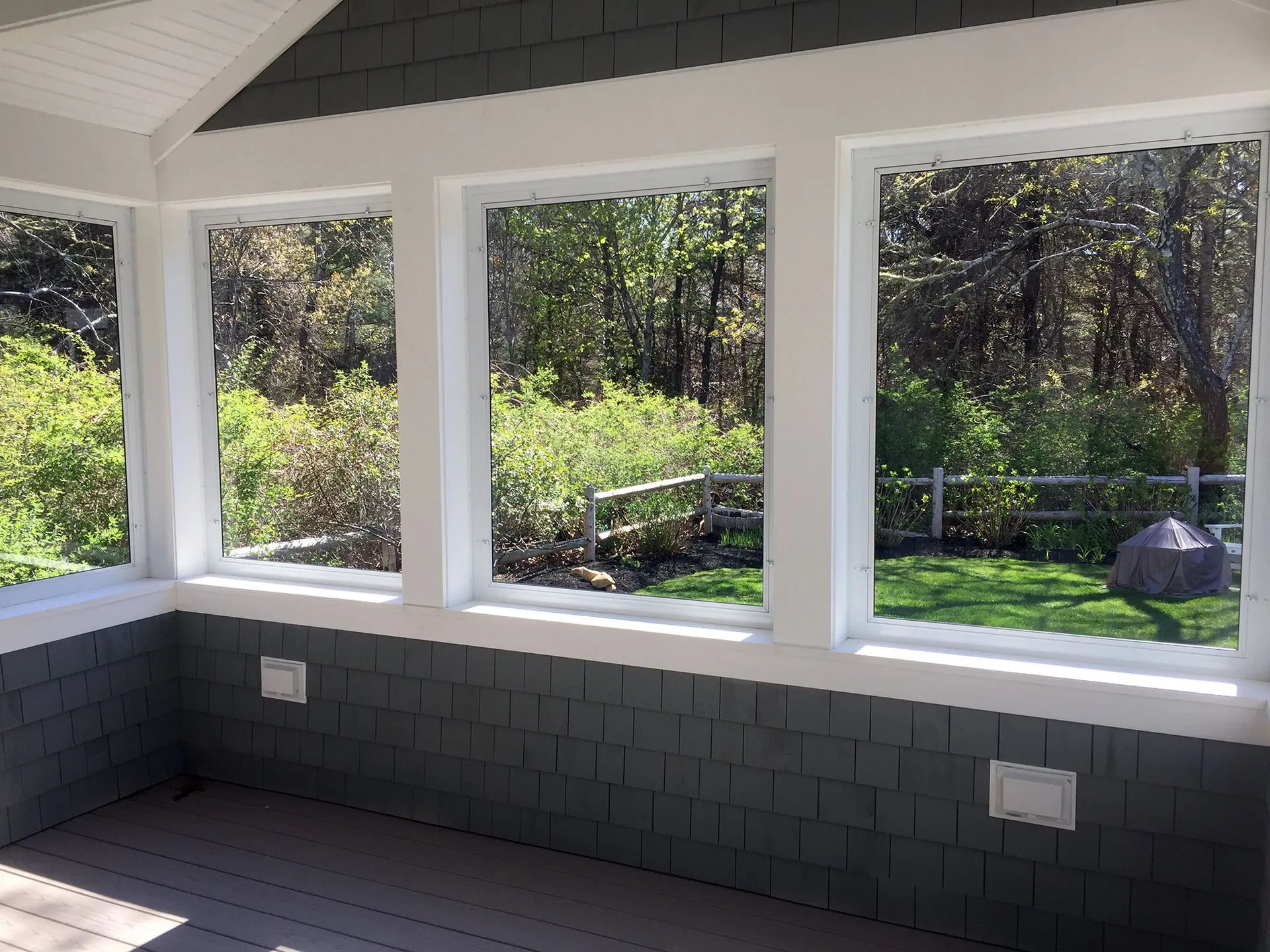 a room with a lot of windows and a view of trees