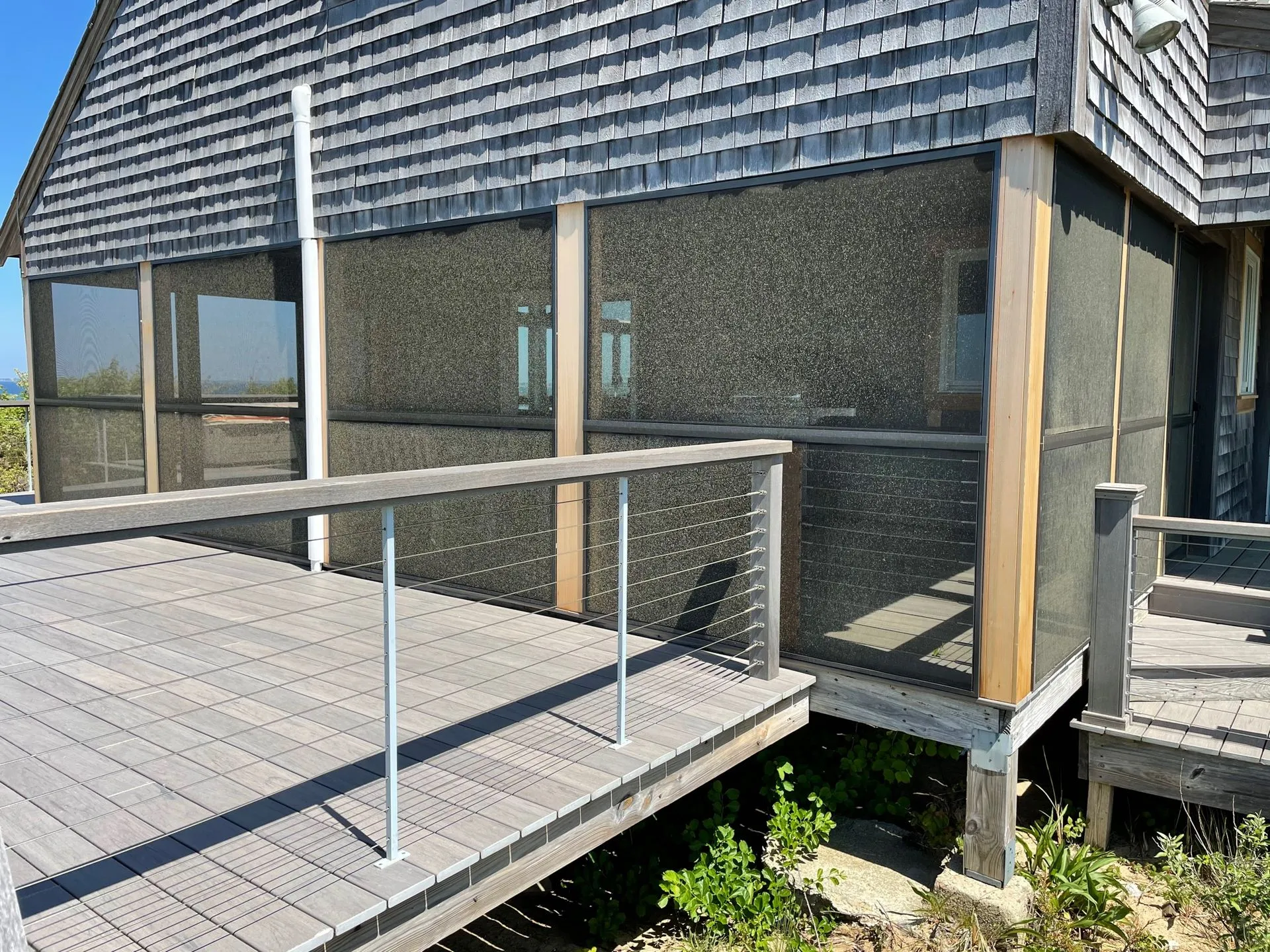 a screened in porch on the side of a house