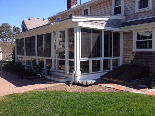there is a screened in porch on the side of a house