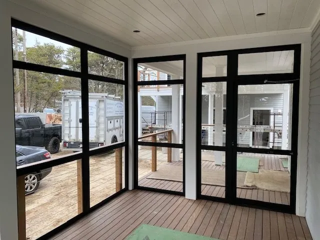 a screened in porch with a lot of windows