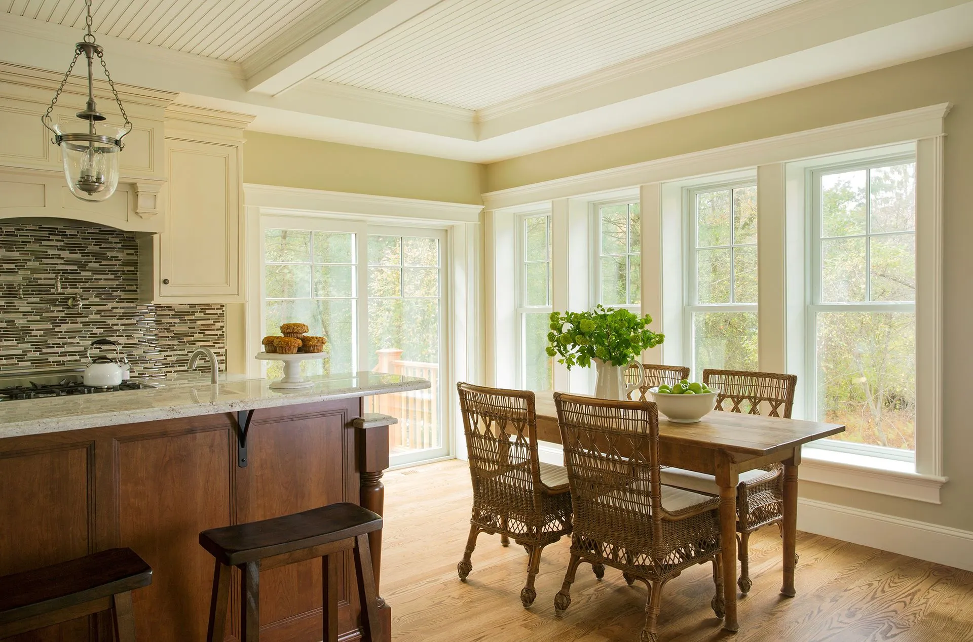 a kitchen with a table and chairs and lots of windows
