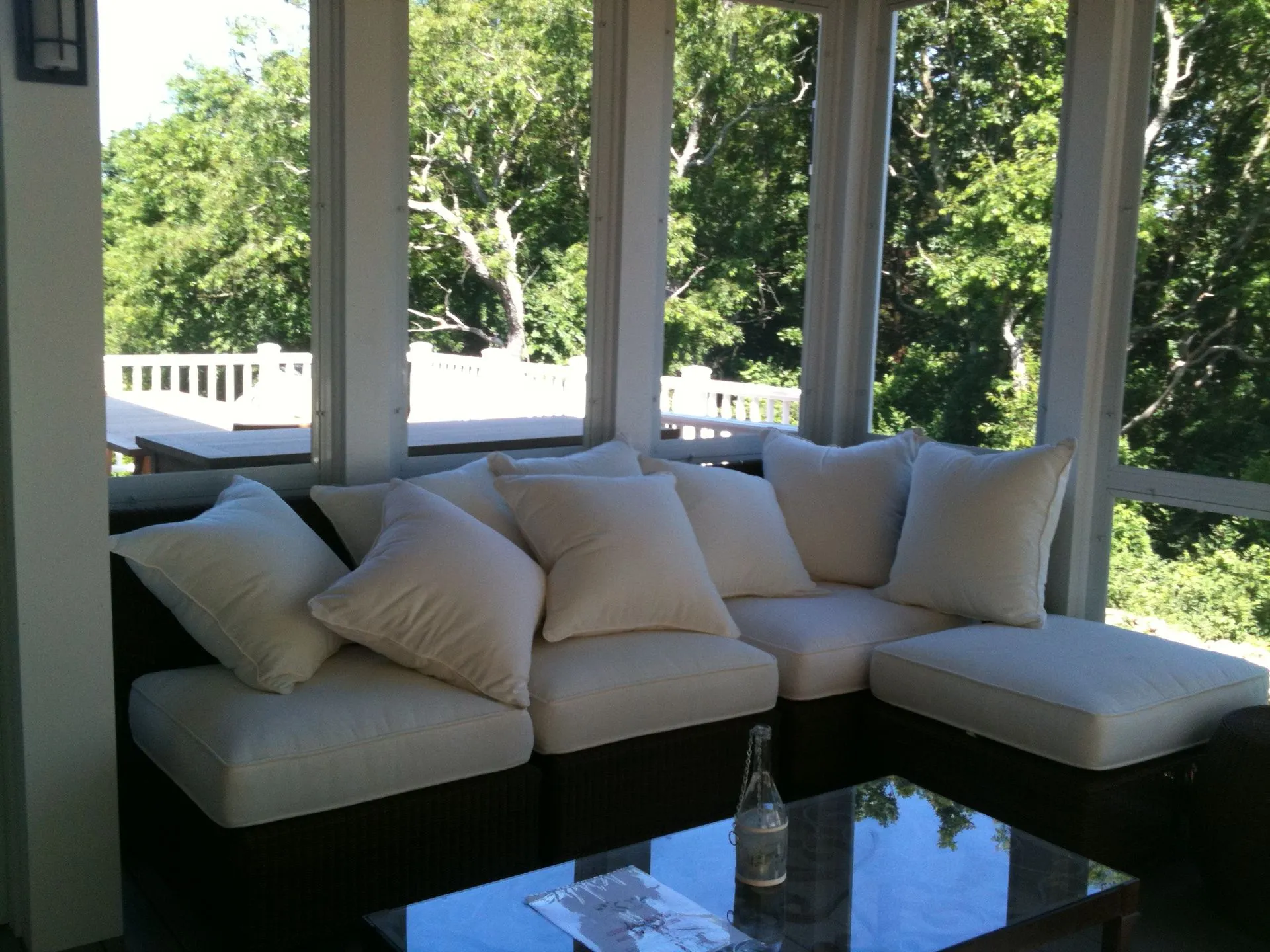 a screened in porch with a couch and a table