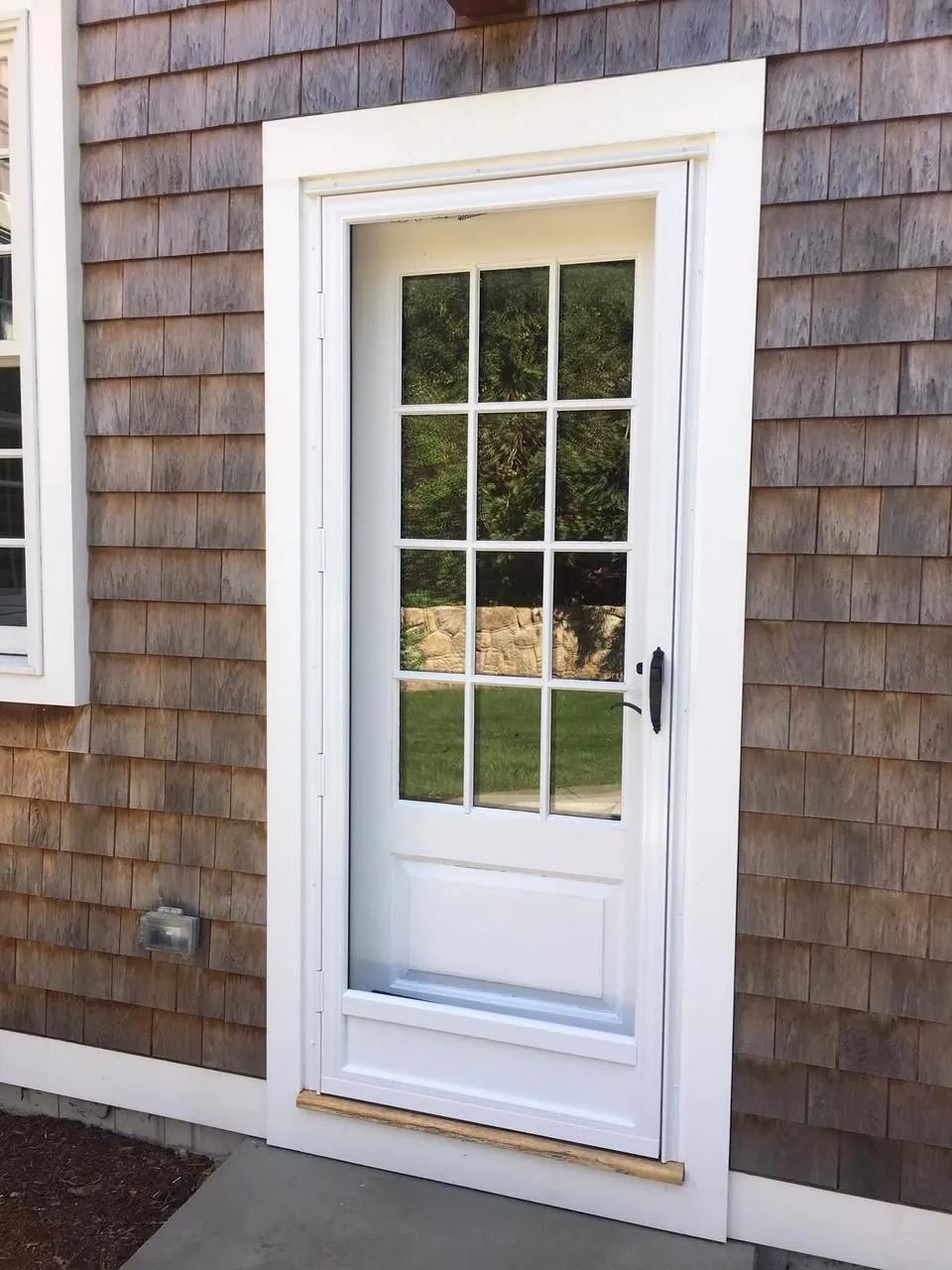 a white door is on the side of a house