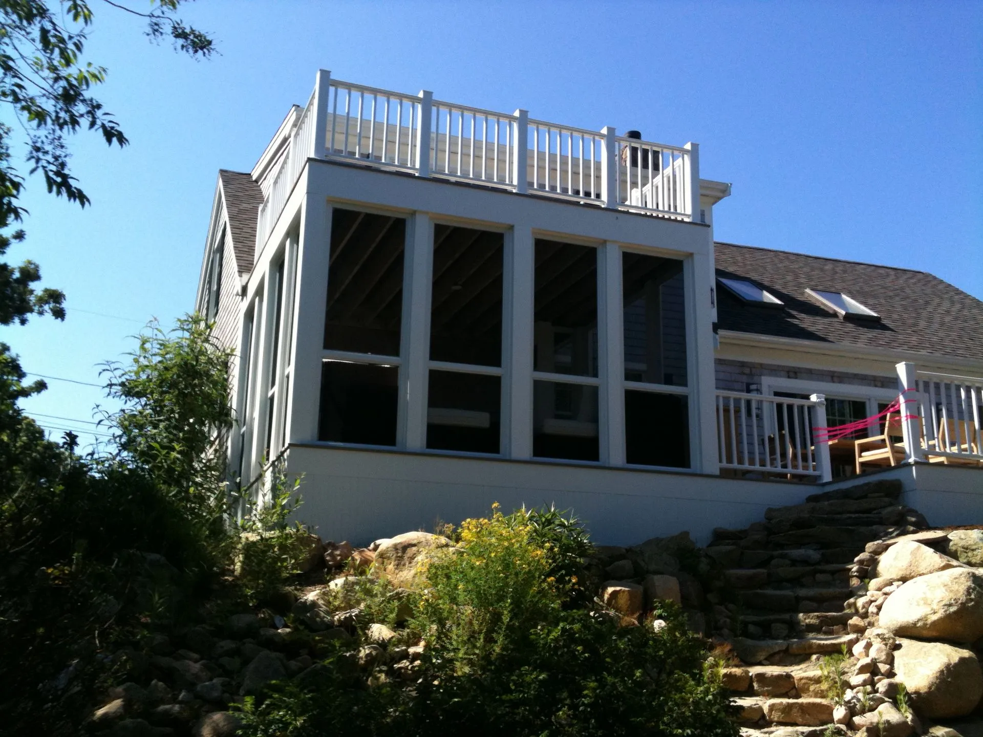 a house with a screened in porch and stairs